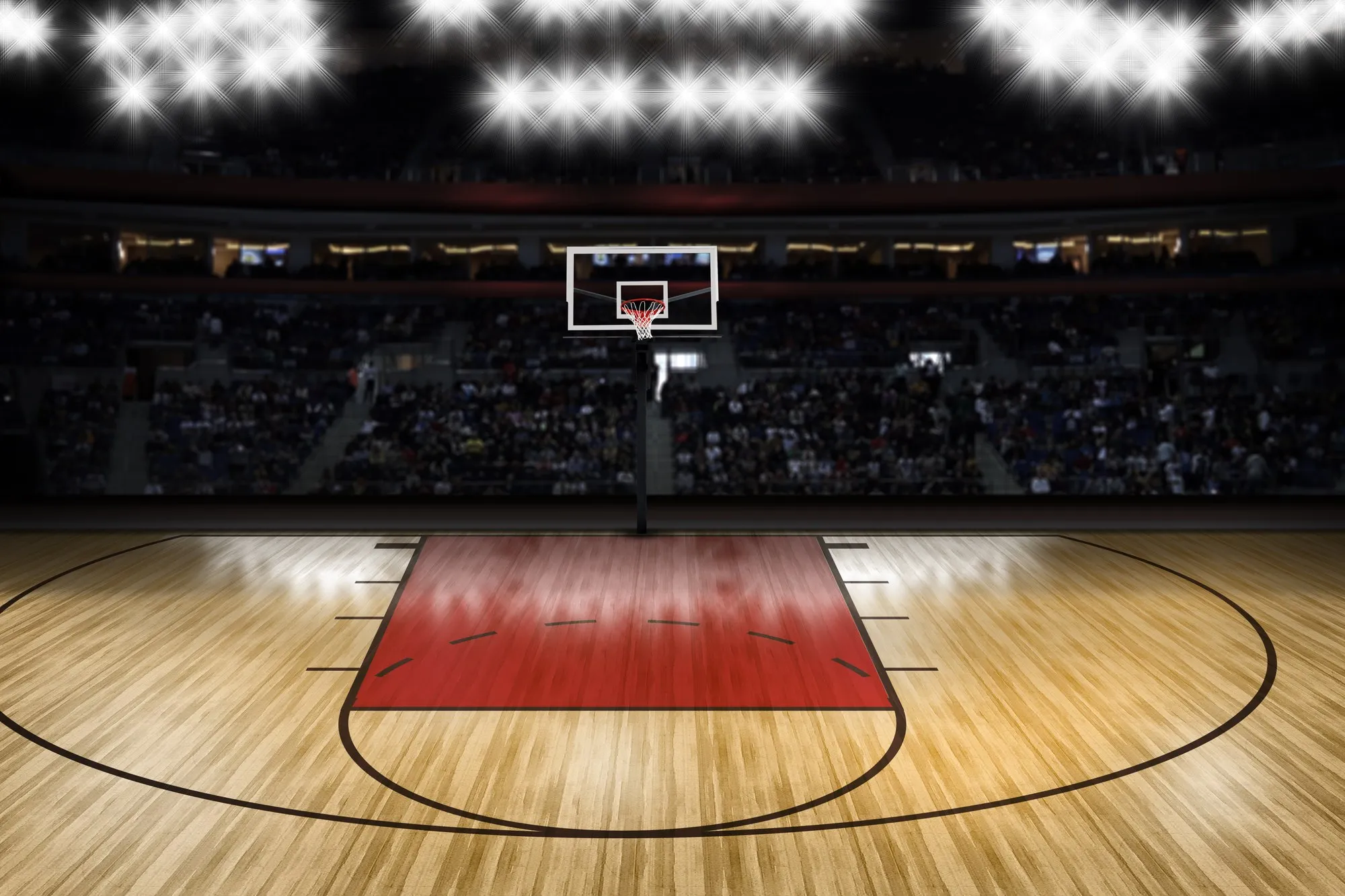 A basketball arena lit for a night game, the court empty